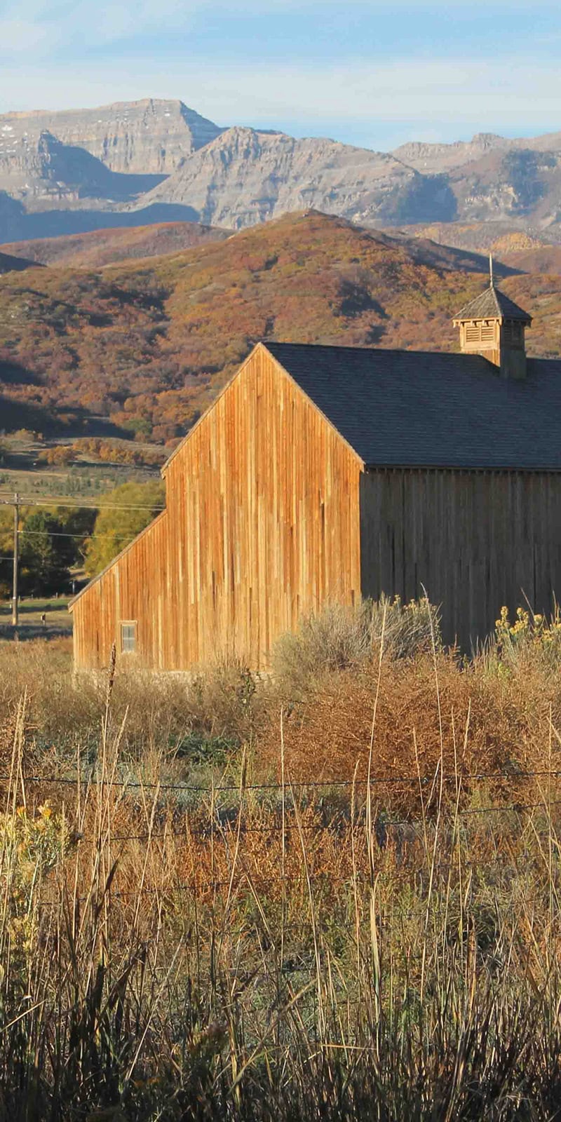 A barn nestled next to the mountains in Midway, Utah