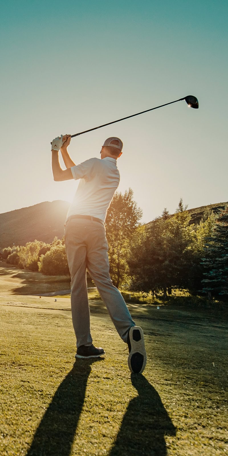 A golfer driving a ball at Homestead Golf Club in Midway, Utah