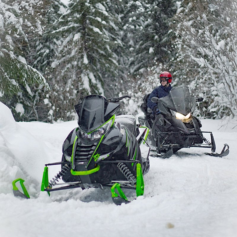 Snow mobiles cruising through the snow
